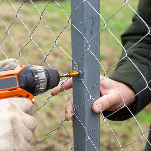 Man building a fence at his dacha