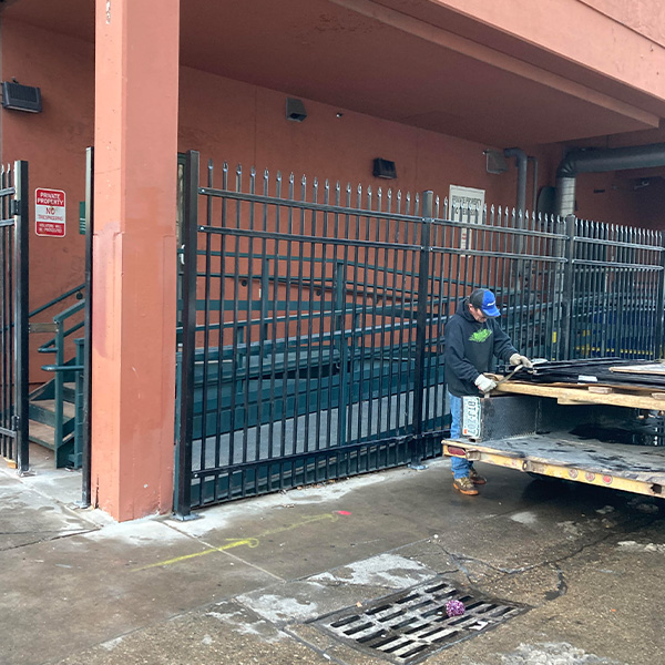 Man installing new security fence around building