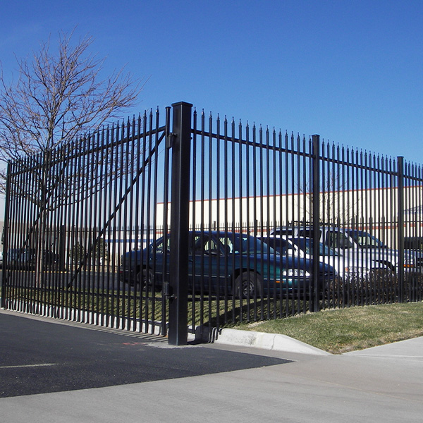 A black metal fence around parking lot
